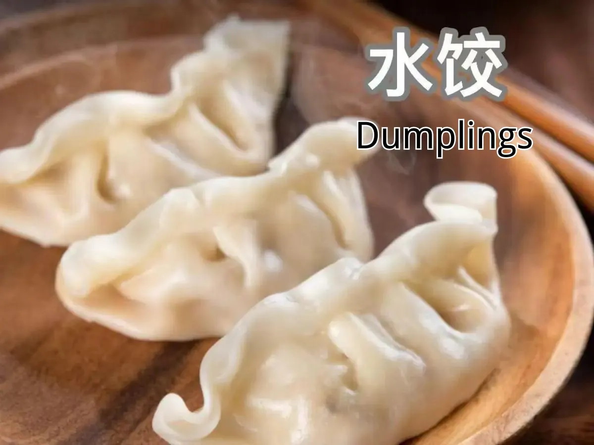 Steamed dumplings on a wooden plate at Yums, a Chinese Restaurant in Memphis.